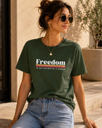 May include: A dark olive green short-sleeve t-shirt featuring the white text Freedom followed by a horizontal striped graphic in yellow, orange, and red, with the additional white text IS MY FAVORITE F-WORD printed underneath.
